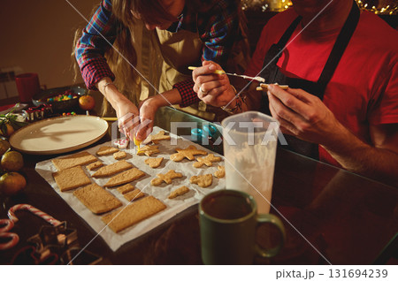 Holiday Cookie Craft: Family And Friends Decorate Christmas Cookies In Cozy Kitchen Holiday Cookie Craft: Family And Friends Decorate Christmas Cookies In Cozy Kitchen 131694239