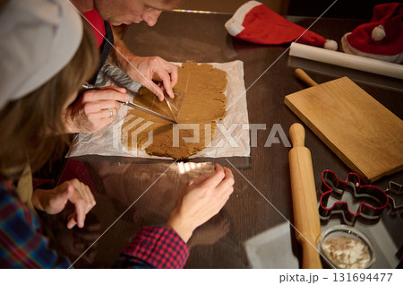Family Baking Christmas Cookies: Cutting Gingerbread Dough Together With Rolling Pin And Cookie Cutters 131694477
