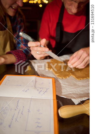 Family Friends Baking Cookies Together: Rolling Dough, Cutting Shapes, and Planning in a Cozy Kitchen Family Friends Baking Cookies Together: Rolling Dough, Cutting Shapes, and Planning in a Cozy Kitchen 131694510