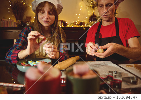 Family Baking Christmas Cookies Together In A Cozy Kitchen With Festive Lights Family Baking Christmas Cookies Together In A Cozy Kitchen With Festive Lights 131694547