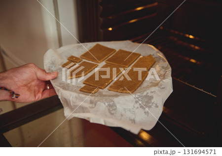 Home Baked Rectangular Cookies On Parchment Paper Ready To Bake In The Oven, Warmth Of Family Kitchen, Cozy Moment Of Homemade Dessert Home Baked Rectangular Cookies On Parchment Paper Ready To Bake In The Oven, Warmth Of Family Kitchen, Cozy Moment Of Homemade Dessert 131694571