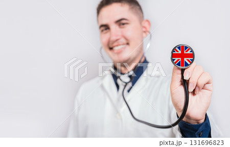 Doctor showing stethoscope with United Kingdom flag. United Kingdom national healthcare concept 131696823