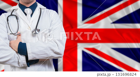 Male doctor with stethoscope on United Kingdom flag. Doctor holding stethoscope on United Kingdom flag 131696824