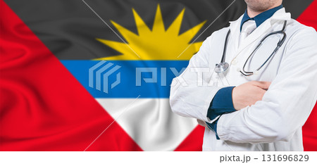 Antigua and Barbuda healthcare concept. Male doctor on Antigua and Barbuda flag. Doctor with crossed arms on Antigua and Barbuda flag Antigua and Barbuda healthcare concept. Male doctor on Antigua and Barbuda flag. Doctor with crossed arms on Antigua and Barbuda flag 131696829