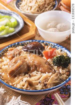 Stir fried chicken and mushroom over rice  131698578