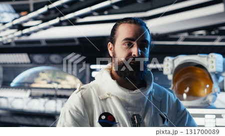 Astronaut studying cosmic origins talks with command center during videocall to share recent discoveries. Cosmonaut mapping unknown worlds provides scientific findings to Earth team Astronaut studying cosmic origins talks with command center during videocall to share recent discoveries. Cosmonaut mapping unknown worlds provides scientific findings to Earth team 131700089
