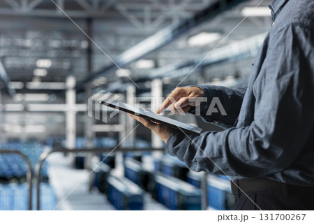 Close up of tablet used by data center technician to manage software updates for system stability. Server room IT expert optimizing performance with device, configuring infrastructure Close up of tablet used by data center technician to manage software updates for system stability. Server room IT expert optimizing performance with device, configuring infrastructure 131700267