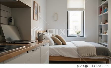 Cozy Modern Bedroom with Warm Decor and Work Desk in Bright Natural Light 131701922