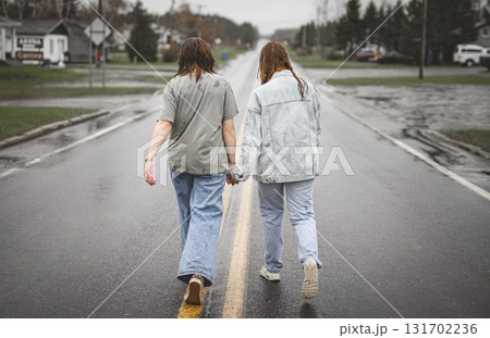 Lesbian Couple Together Outdoors in a rainy day 131702236