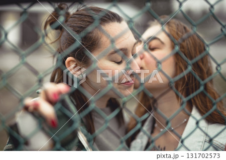 Lesbian Couple Together Outdoors in a rainy day Lesbian Couple Together Outdoors in a rainy day 131702573