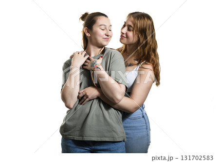 Happy lesbian couple on studio white background. Happy lesbian couple on studio white background. 131702583