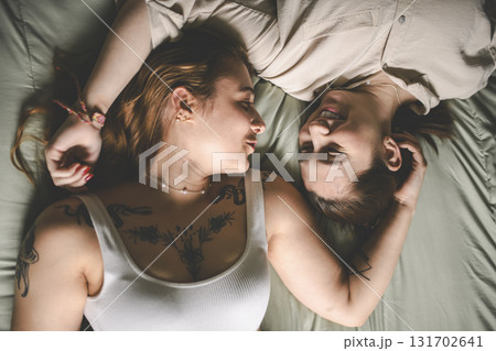 Happy couple having great time close to a window at home Happy couple having great time close to a window at home 131702641