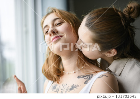 Happy couple having great time close to a window at home 131702645