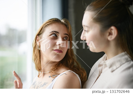 Happy couple having great time close to a window at home 131702646