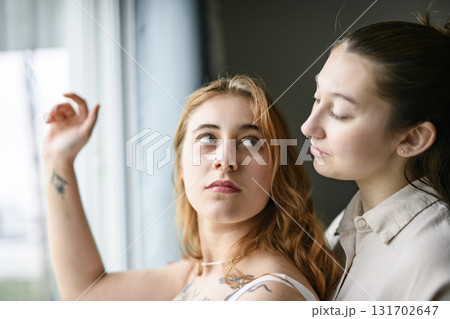 Happy couple having great time close to a window at home 131702647