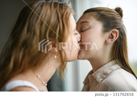 Happy couple having great time close to a window at home. 131702658