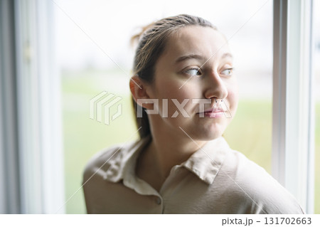 beautiful young woman in the bedroom close to a window 131702663