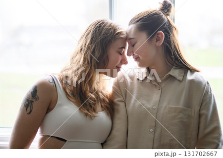 Happy couple having great time close to a window at home. 131702667