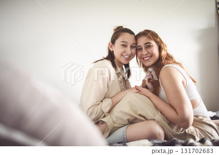 Happy couple cuddling on their bed at home. Romantic young LGBTQ 131702683
