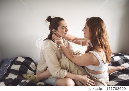 Happy couple cuddling on their bed at home. Romantic young LGBTQ Happy couple cuddling on their bed at home. Romantic young LGBTQ 131702690