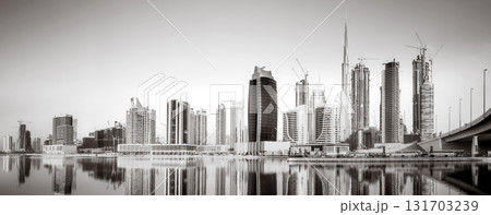 Skyscrapers and bridge over water, black and white style, city background, Dubai Marina bay UAE Skyscrapers and bridge over water, black and white style, city background, Dubai Marina bay UAE 131703239
