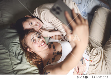 Happy couple cuddling on their bed at home. Romantic young LGBTQ Happy couple cuddling on their bed at home. Romantic young LGBTQ 131703563