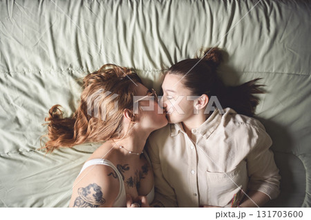 Happy couple cuddling on their bed at home. Romantic young LGBTQ Happy couple cuddling on their bed at home. Romantic young LGBTQ 131703600