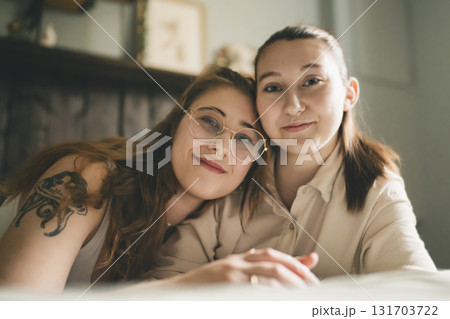Happy couple cuddling on their bed at home. Romantic young LGBTQ Happy couple cuddling on their bed at home. Romantic young LGBTQ 131703722