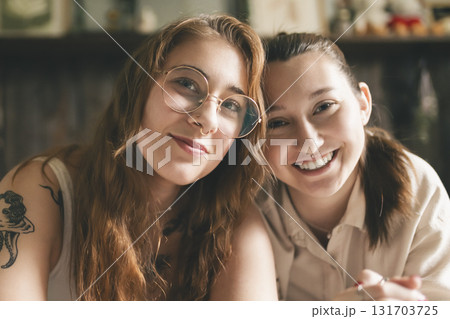 Happy couple cuddling on their bed at home. Romantic young LGBTQ Happy couple cuddling on their bed at home. Romantic young LGBTQ 131703725