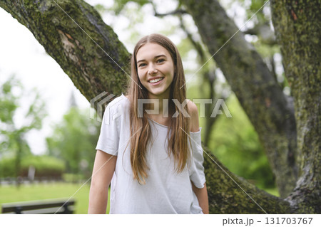 Portrait of teenage girl in casual t-shirt outside on summer season 131703767