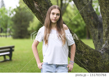Portrait of teenage girl in casual t-shirt outside on summer season 131703768