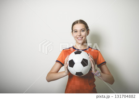 one caucasian young soccer player girl standing in studio gray background one caucasian young soccer player girl standing in studio gray background 131704882