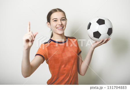 one caucasian young soccer player girl standing in studio gray background one caucasian young soccer player girl standing in studio gray background 131704883