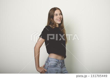 Portrait of teenage girl in casual t-shirt on light background in studio. Portrait of teenage girl in casual t-shirt on light background in studio. 131705449