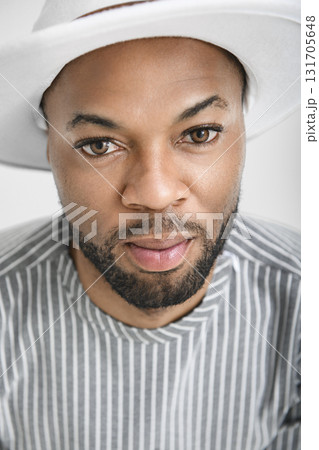 Portrait of black fashion American wearing great looking clothes with white hat 131705648