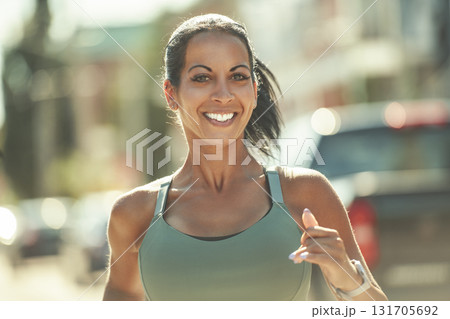 Happy sporty woman jogging outdoors in urban scene Happy sporty woman jogging outdoors in urban scene 131705692