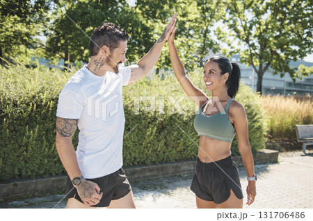 Young fitness couple running on a city on summer day 131706486
