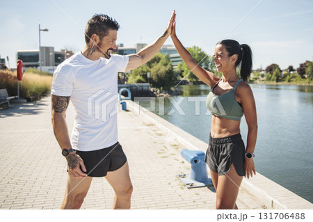 Young fitness couple running on a city on summer day 131706488