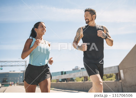Young fitness couple running on a city on summer day 131706506
