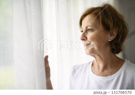 senior woman relax at home appartement close to window senior woman relax at home appartement close to window 131706570