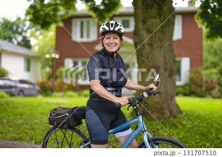 Happy mature cyclist woman enjoying healthy activity Happy mature cyclist woman enjoying healthy activity 131707510