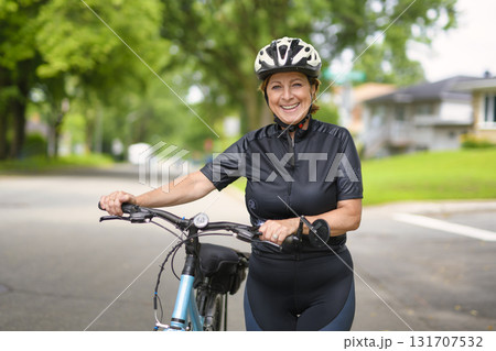 Happy mature cyclist woman enjoying healthy activity Happy mature cyclist woman enjoying healthy activity 131707532