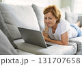 Happy modern European senior woman using laptop 131707658