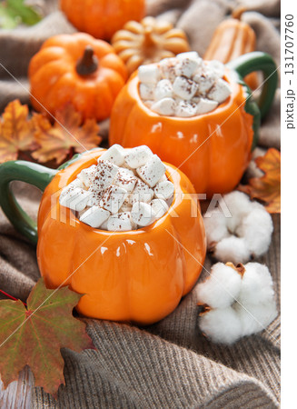 Two pumpkin mugs with hot chocolate and marshmallows 131707760