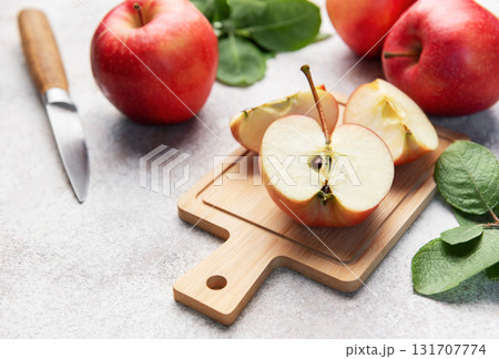 Red apples slicing on cutting board ready for healthy snack 131707774