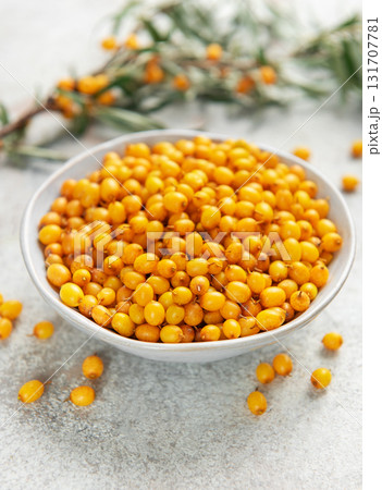 Sea buckthorn berries in bowl with branches 131707781