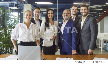 Success of business meeting, happy entrepreneurs standing in row at desk 131707969