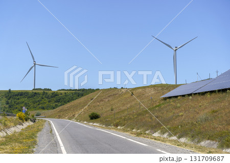 Highway with Solar Panels and Wind Turbines. Green Energy Landscape 131709687