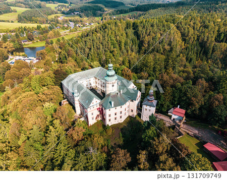 Experience a stunning aerial view of Lemberk Castle surrounded by lush greenery and rolling hills. This historic site captures the beauty of nature and architecture in one scene. Experience a stunning aerial view of Lemberk Castle surrounded by lush greenery and rolling hills. This historic site captures the beauty of nature and architecture in one scene. 131709749