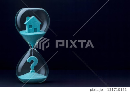 Hourglass with blue sand house and question mark on dark background showing real estate timing and uncertainty 131710131